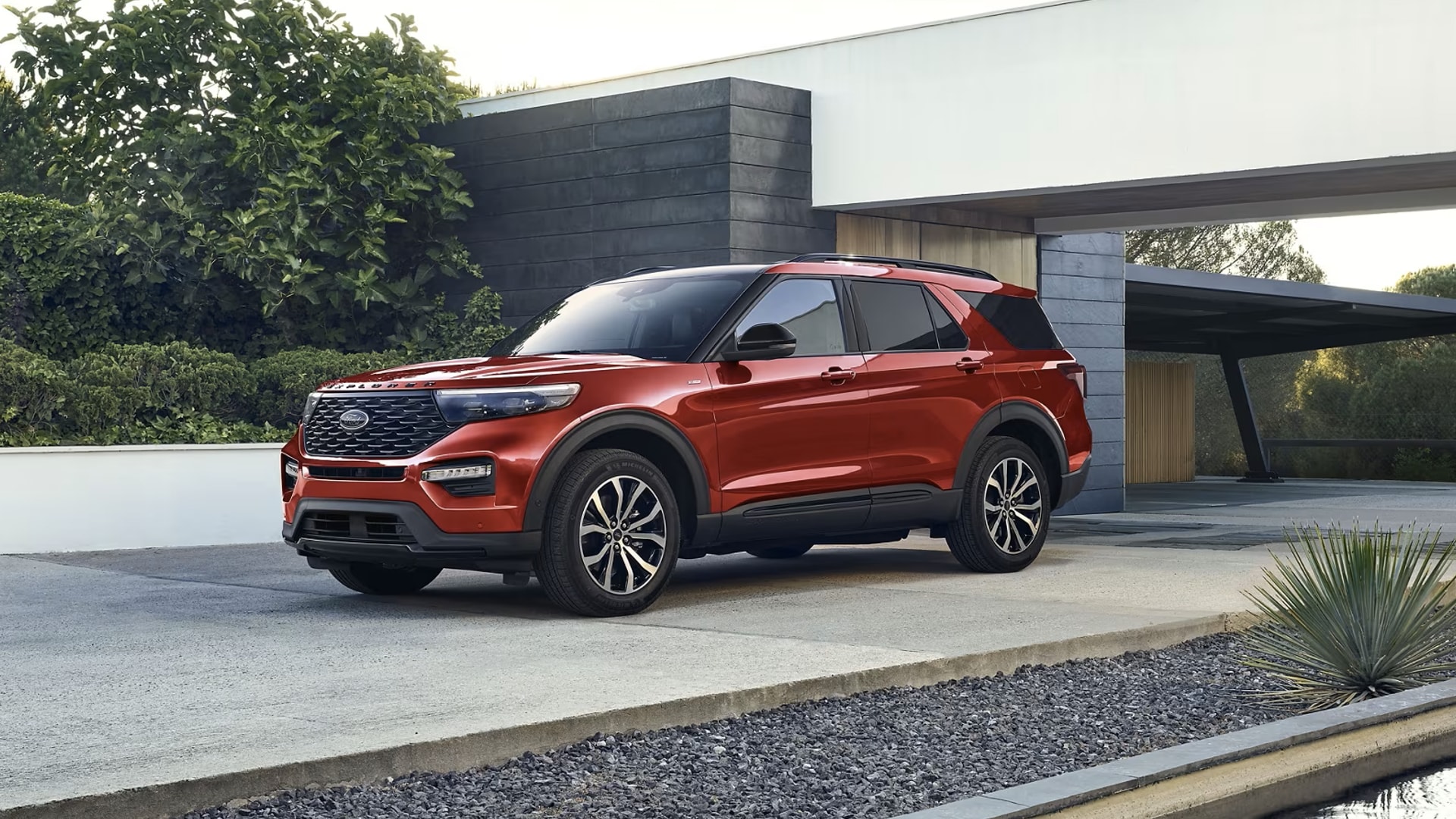 Ford Explorer parked in the driveway of a modern home