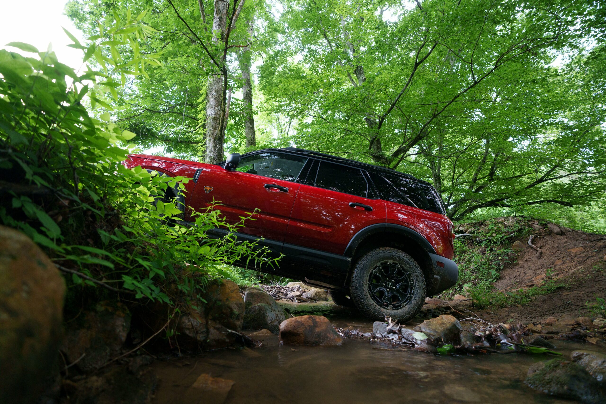 A 2026 Ford Bronco Sport Badlands climbing a rocky stream bed