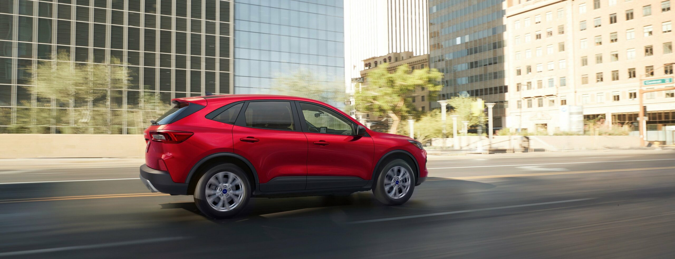 A 2026 Ford Escape Active in Rapid Red on a city street