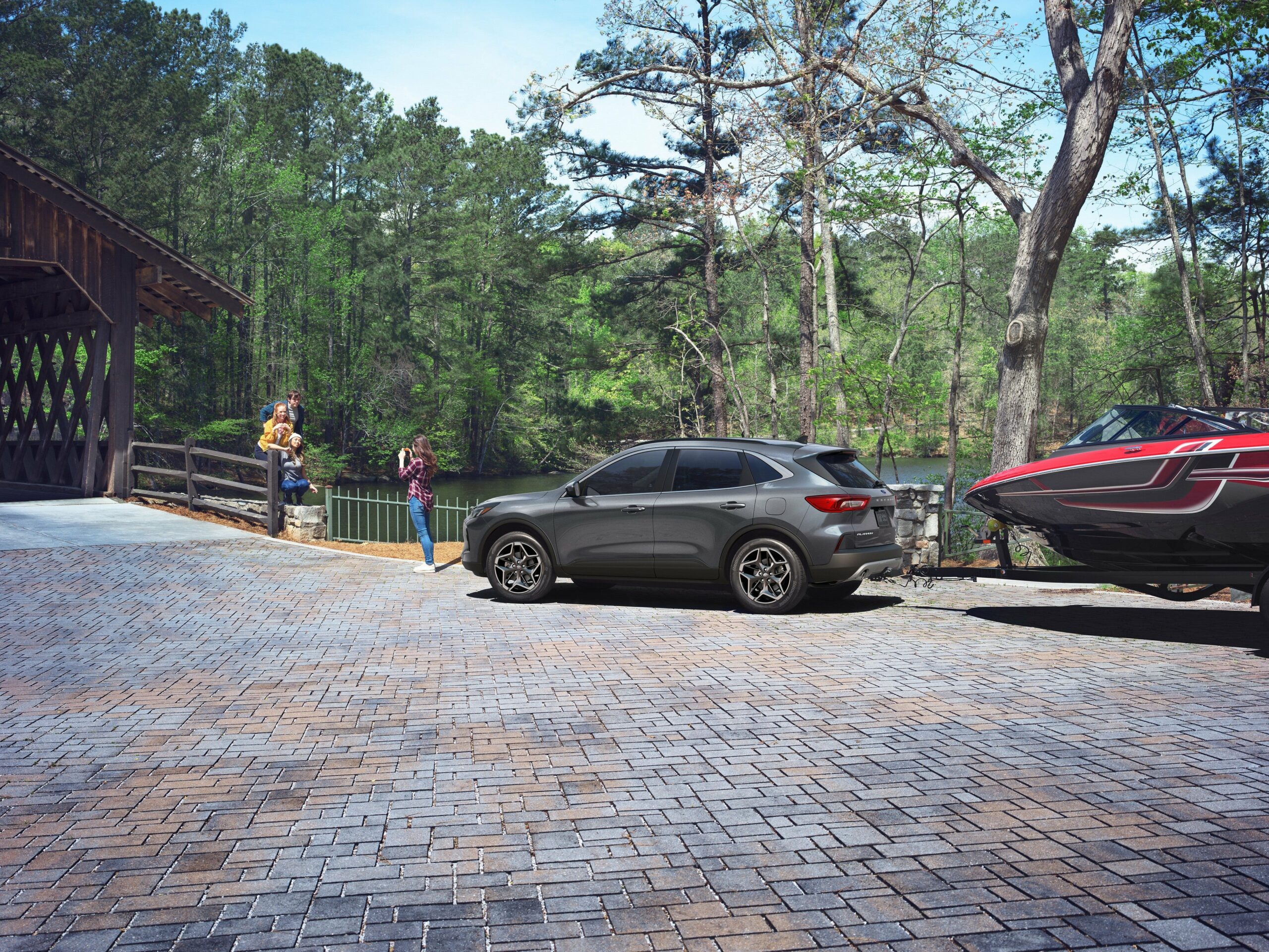 A gray 2026 Ford Escape on a brick street lined with trees