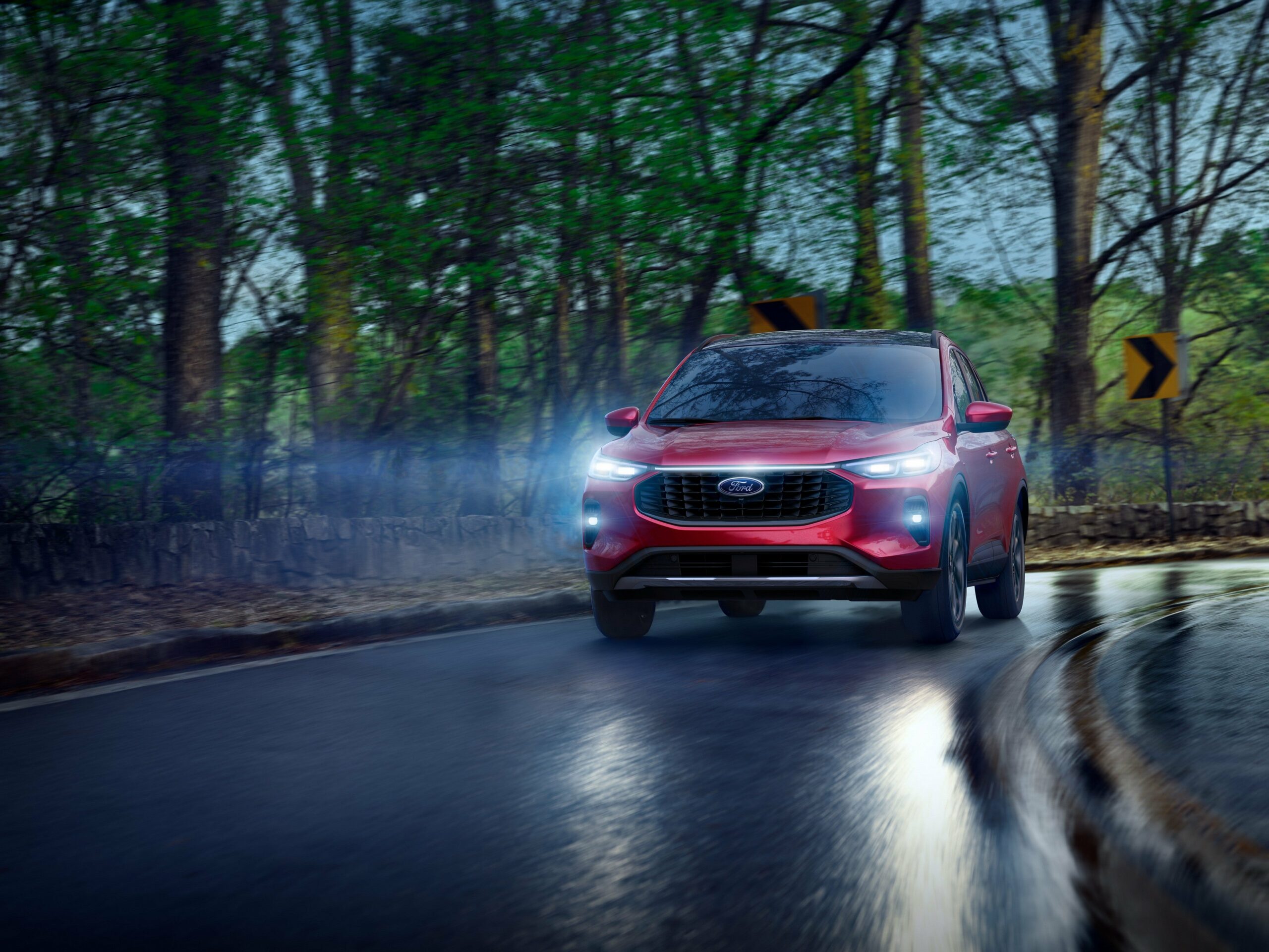 A 2026 Ford Escape on a wet road at dusk with its headlights on