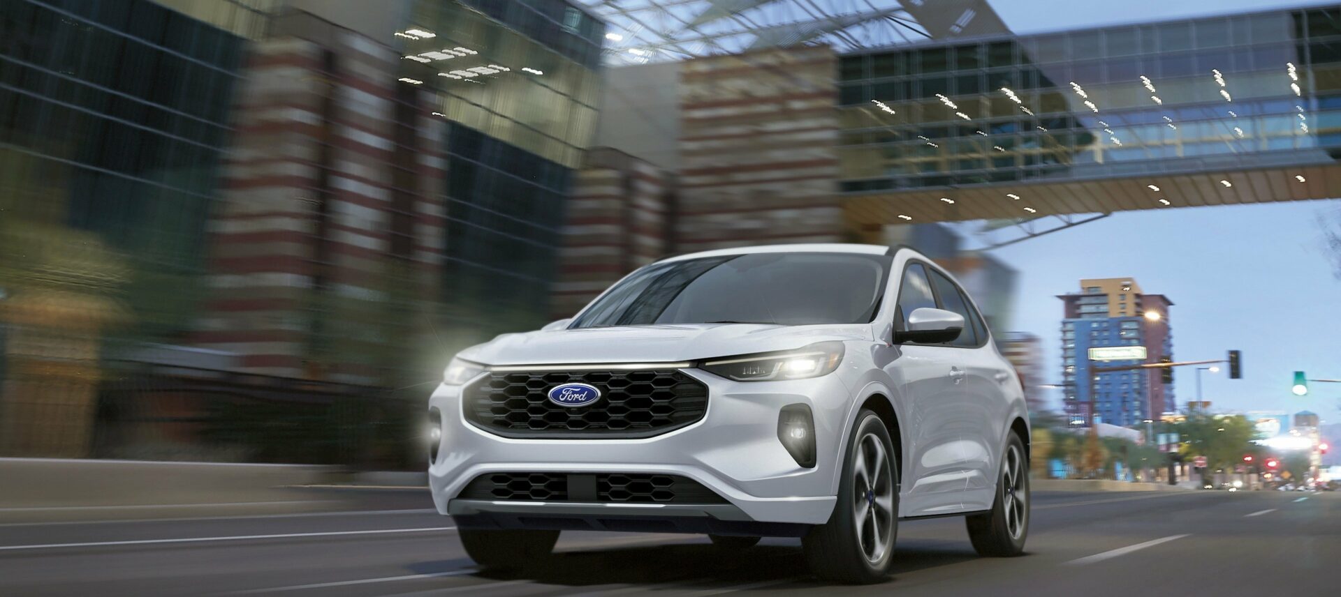 A white 2026 Ford Escape driving under a bridge