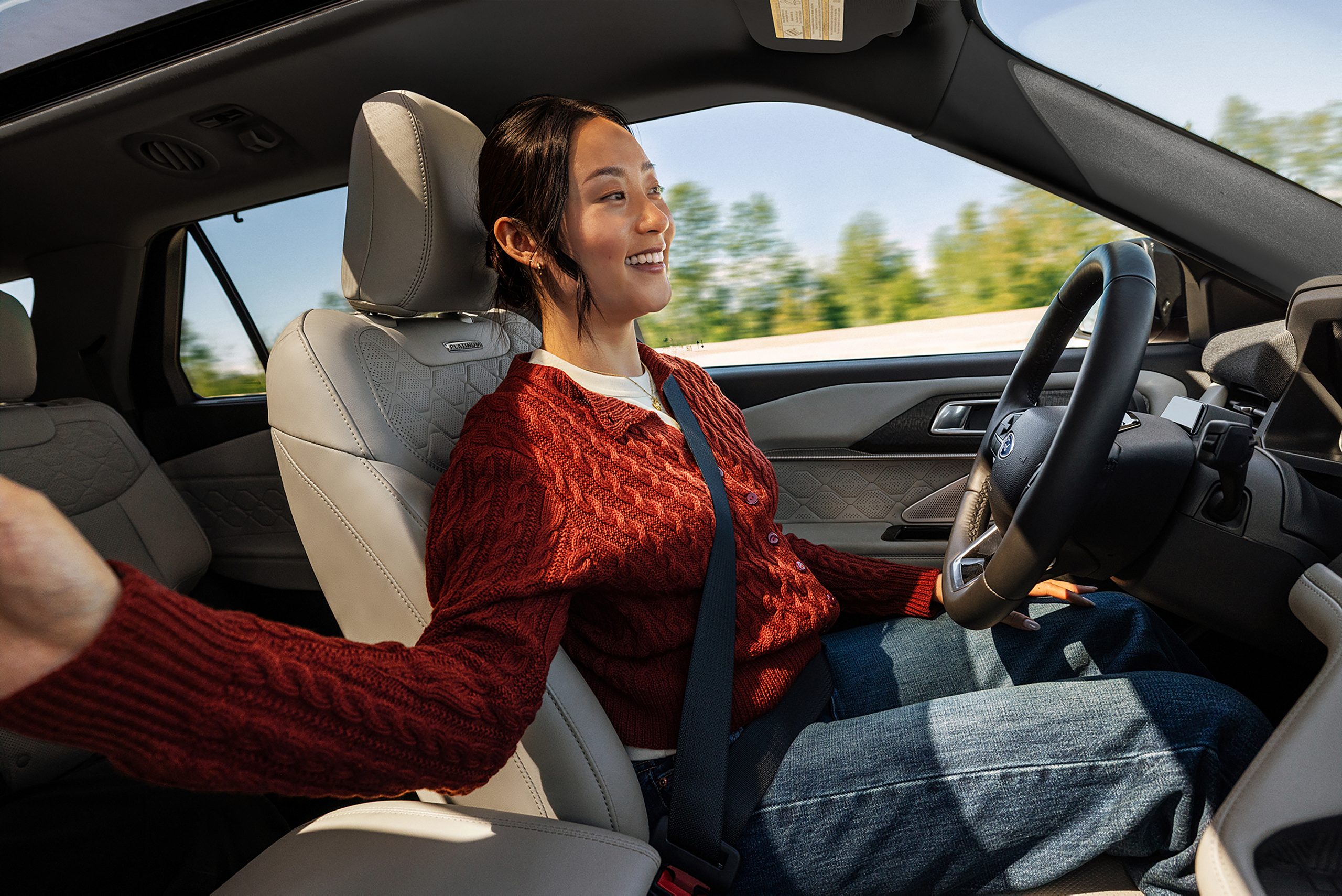 A driver with both hands off the wheel of a 2027 Ford Explorer using BlueCruise
