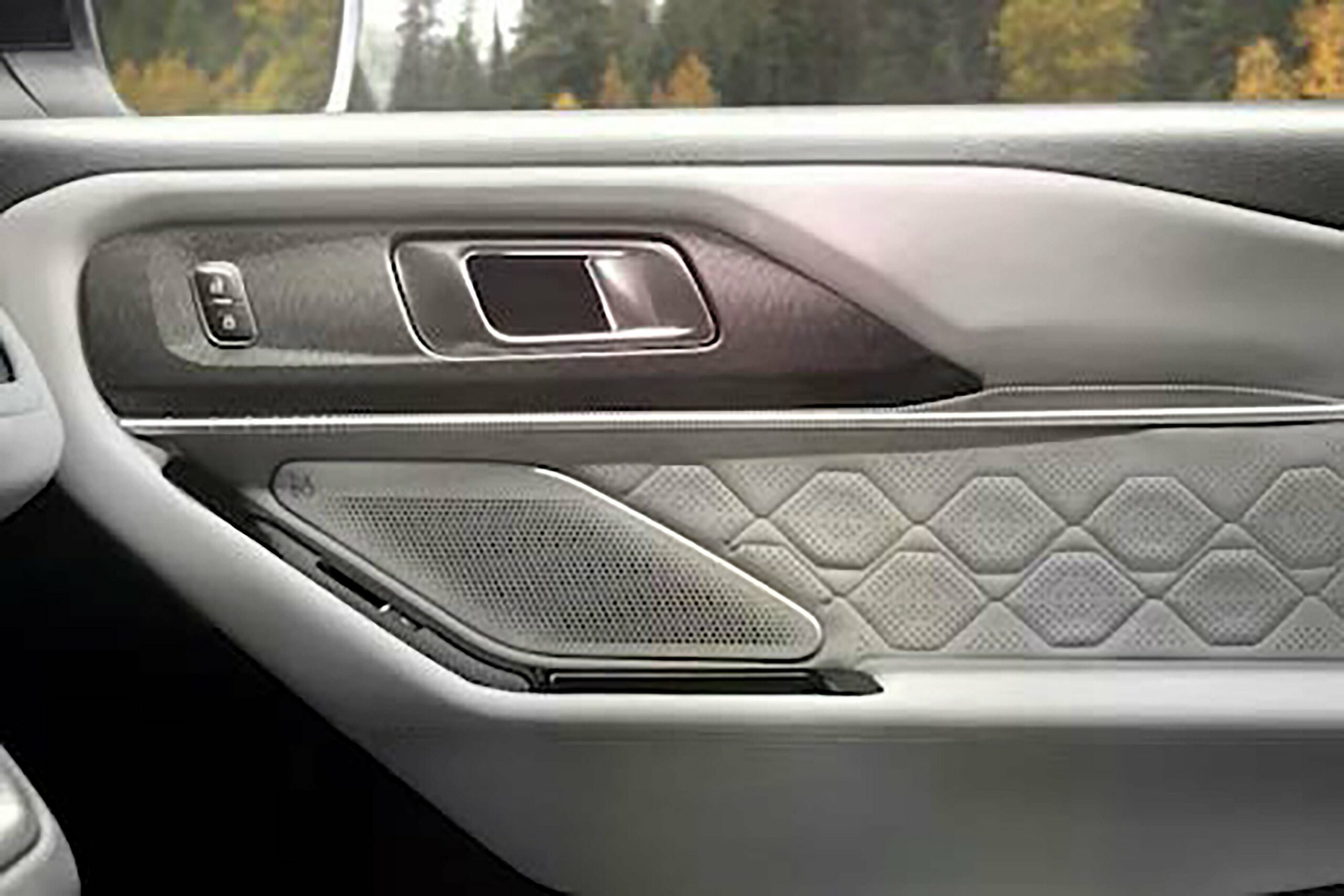 A B and O speaker grille in the front door trim of a 2027 Ford Explorer
