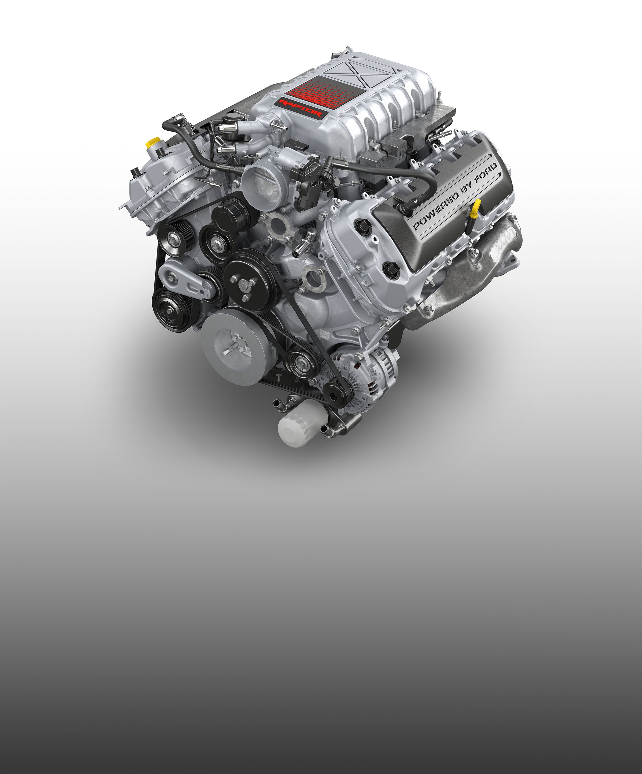 The 5.2L supercharged V8 from the Ford F-150 Raptor R photographed on a white background, its supercharger housing stamped Powered by Ford