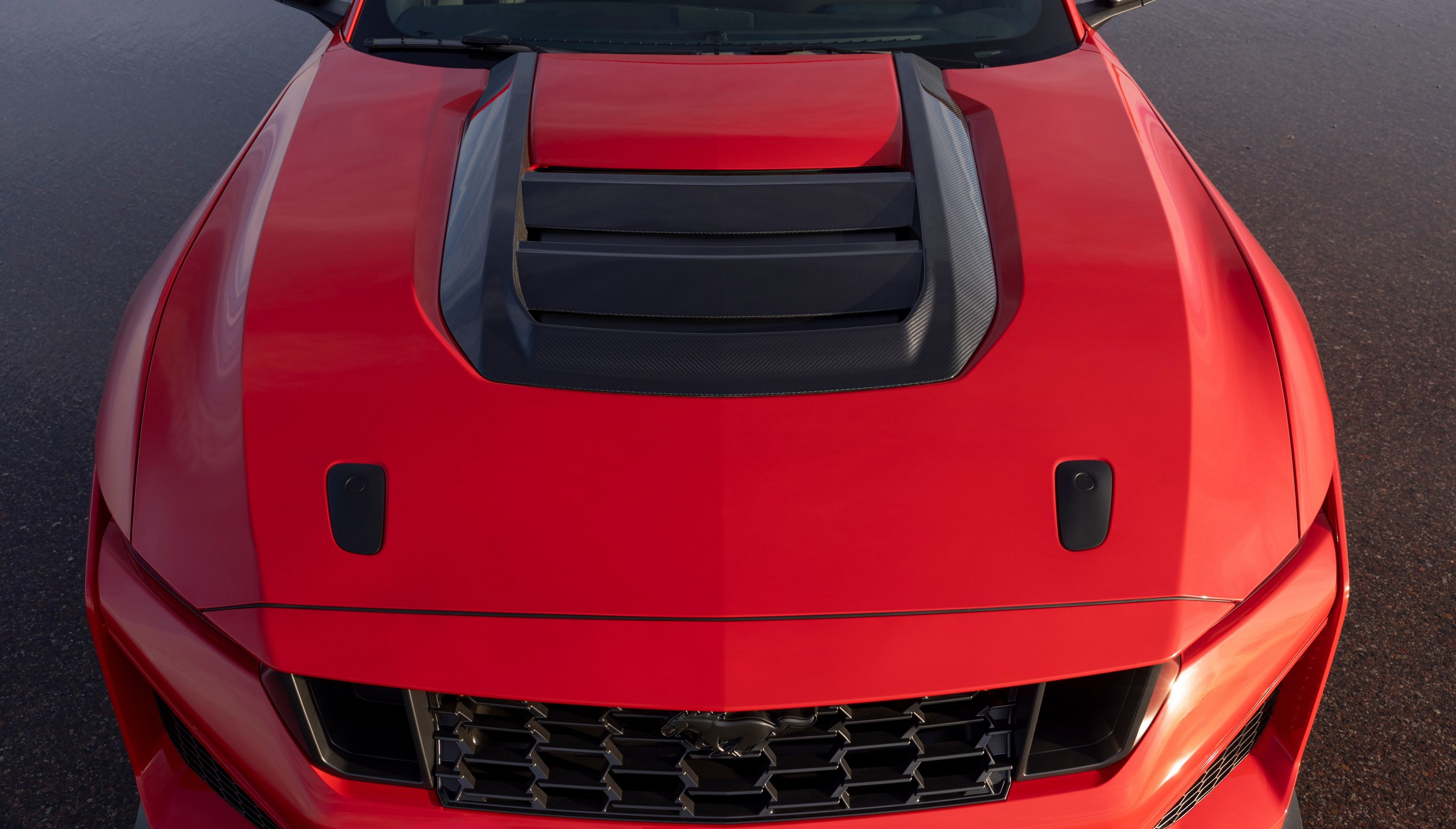 Close view of the black louvered hood vent on the red hood of a 2026 Ford Mustang Dark Horse SC
