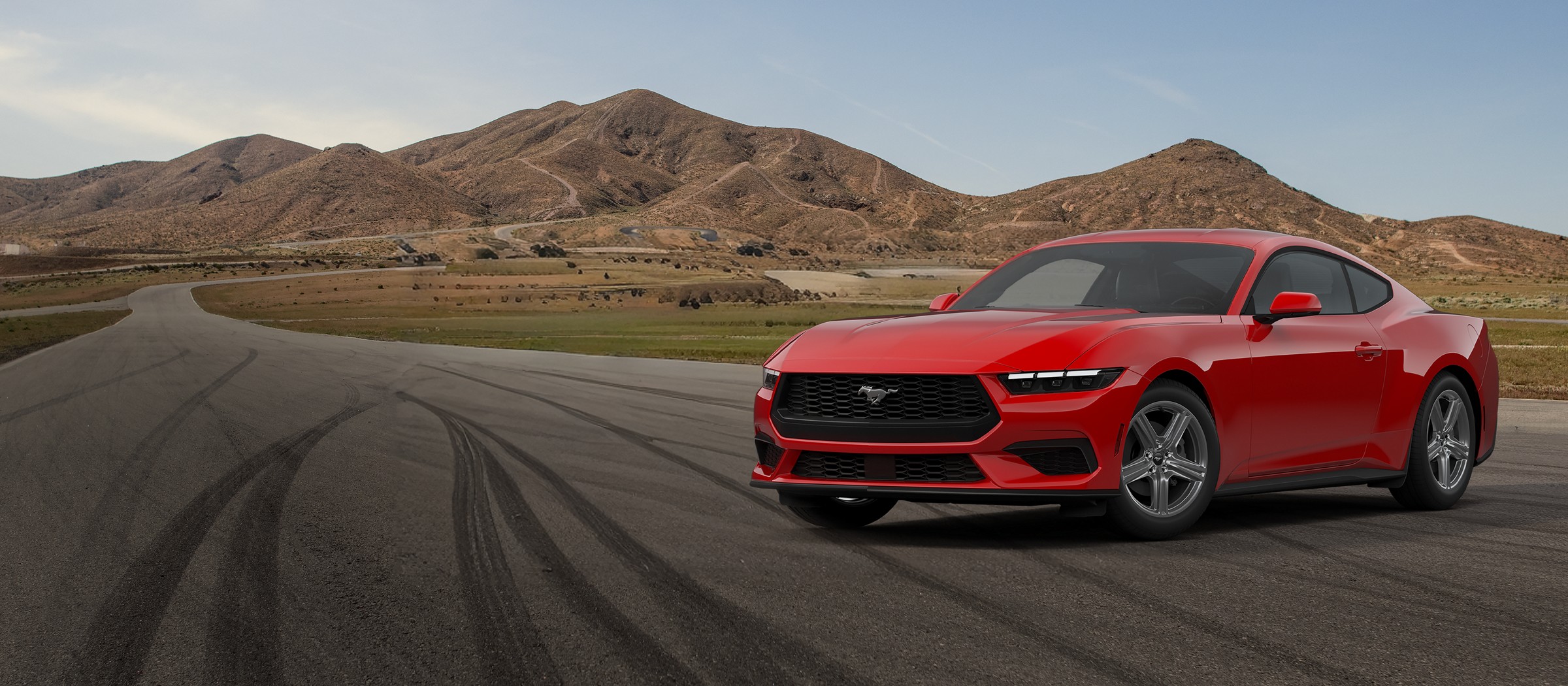 A red 2026 Ford Mustang EcoBoost Fastback on a desert road
