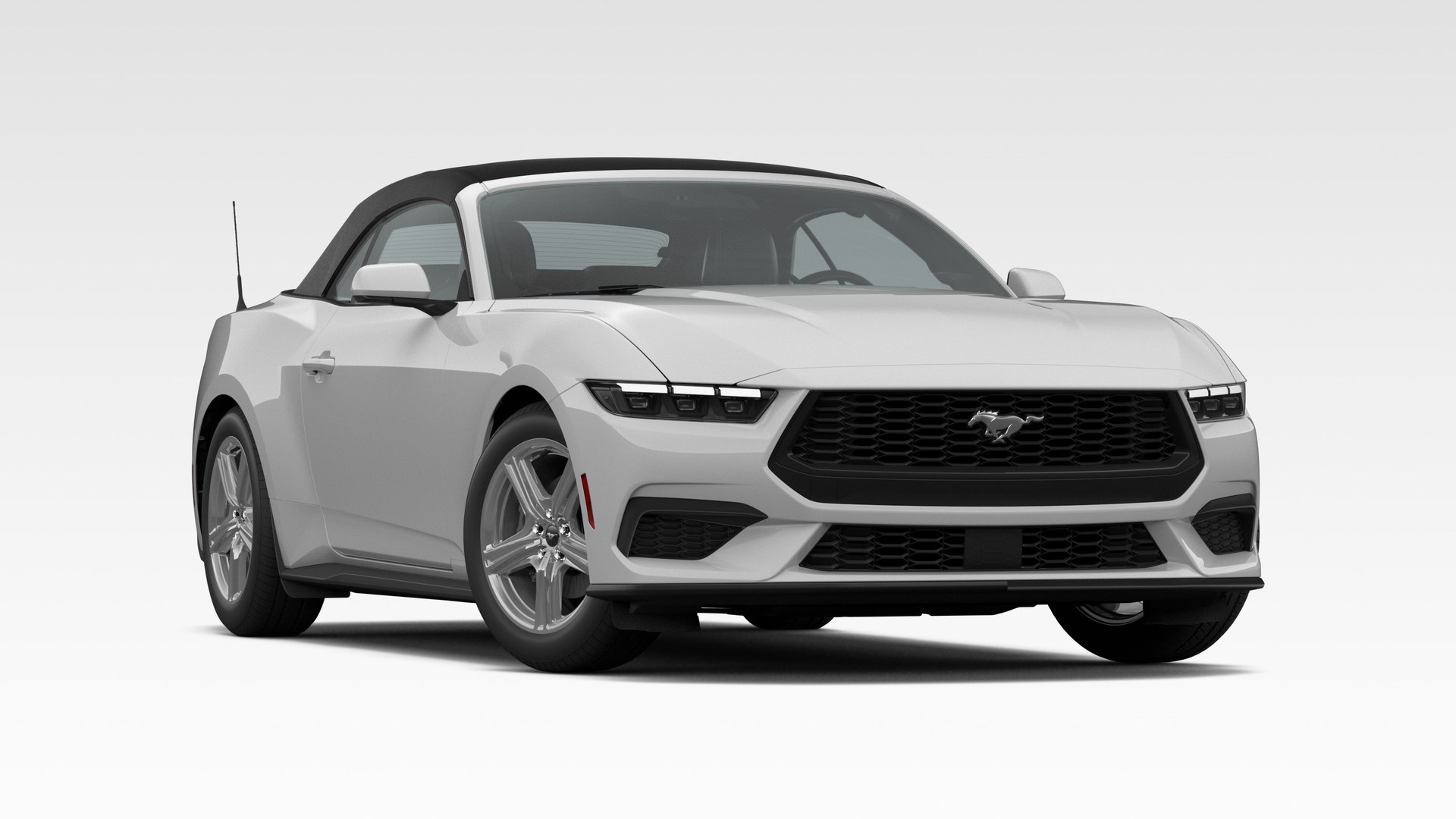 An Avalanche Gray 2026 Ford Mustang EcoBoost Convertible with the black soft top raised, in three-quarter front view