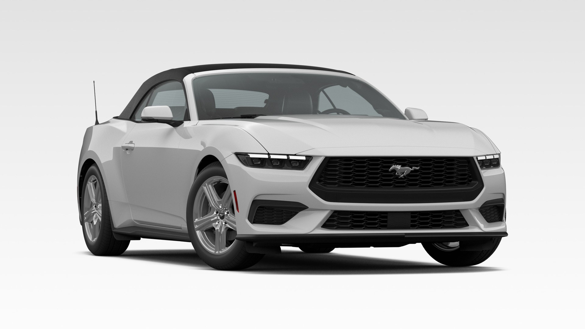 An Avalanche Gray 2026 Ford Mustang EcoBoost Premium Convertible with the black soft top raised, on polished multi-spoke wheels