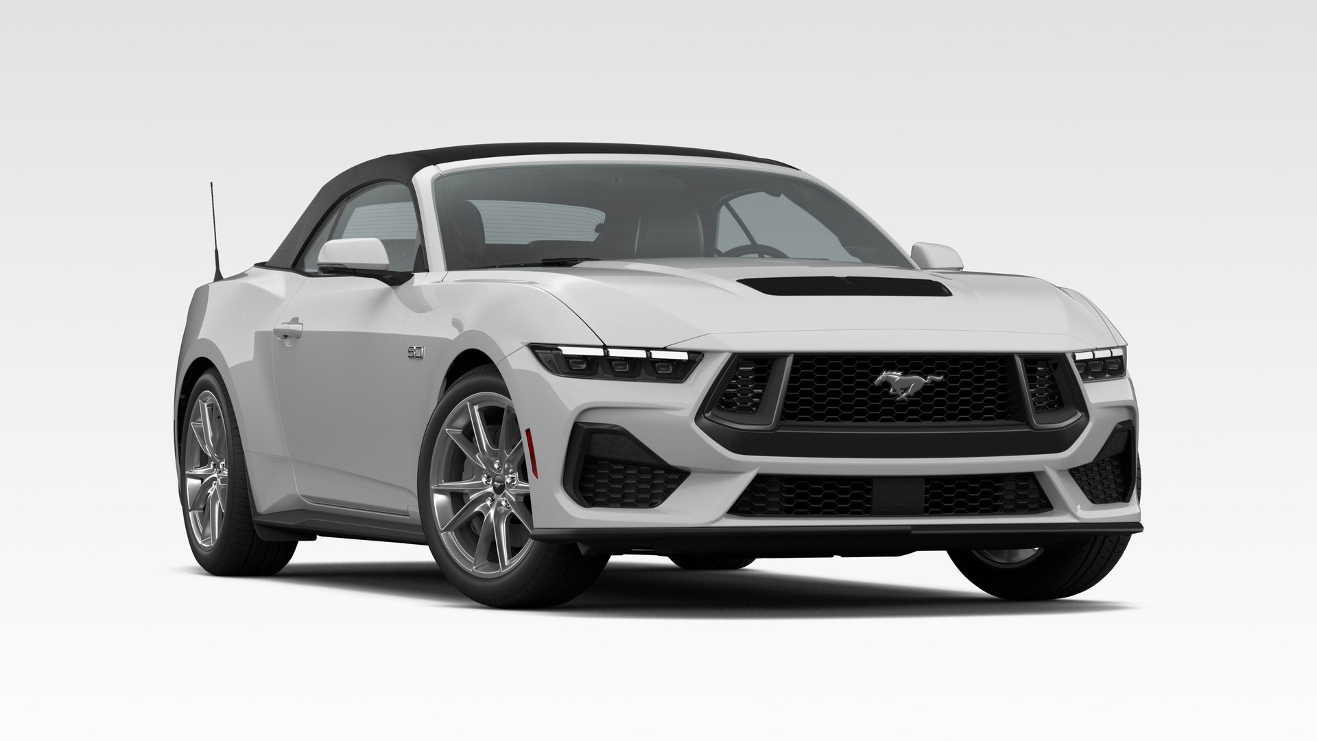 An Avalanche Gray 2026 Ford Mustang GT Premium Convertible with the black soft top raised, showing the GT hood vents