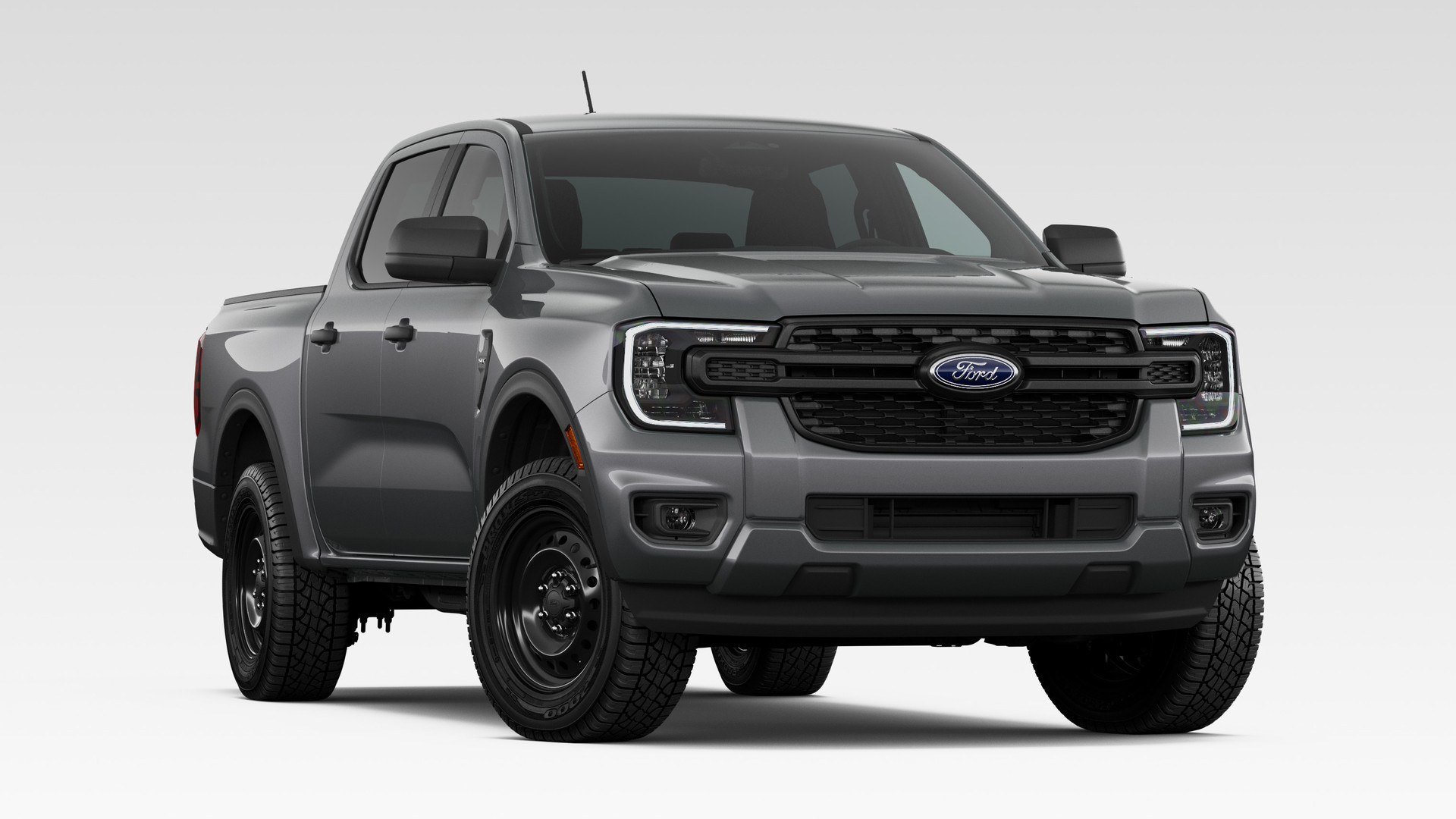 A Carbonized Gray Metallic 2026 Ford Ranger XL SuperCrew with the STX Appearance Package, front three-quarter studio render, on black-painted steel wheels with a dark grille