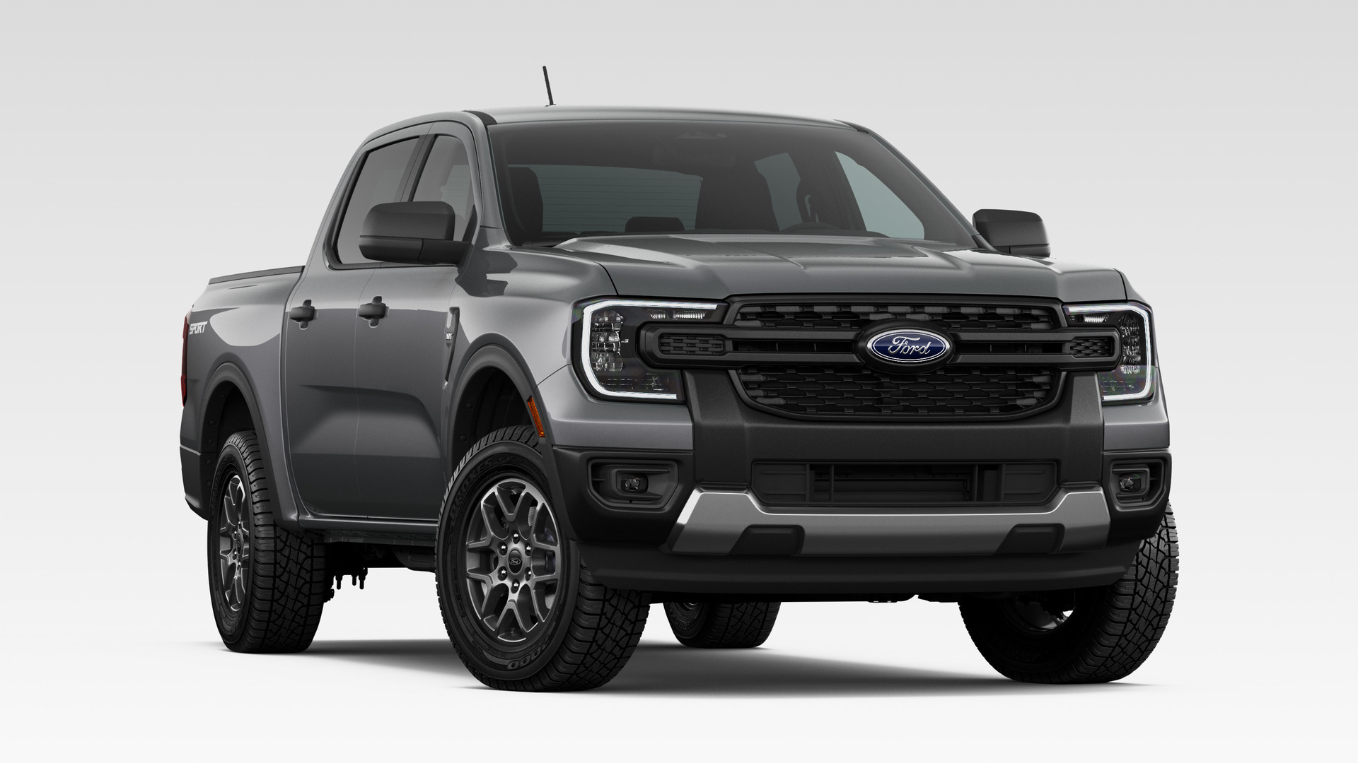 A Carbonized Gray Metallic 2026 Ford Ranger XLT SuperCrew with the Sport Appearance Package, front three-quarter studio render, on machined silver alloy wheels